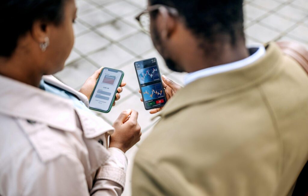 Young colleagues checking an investment app